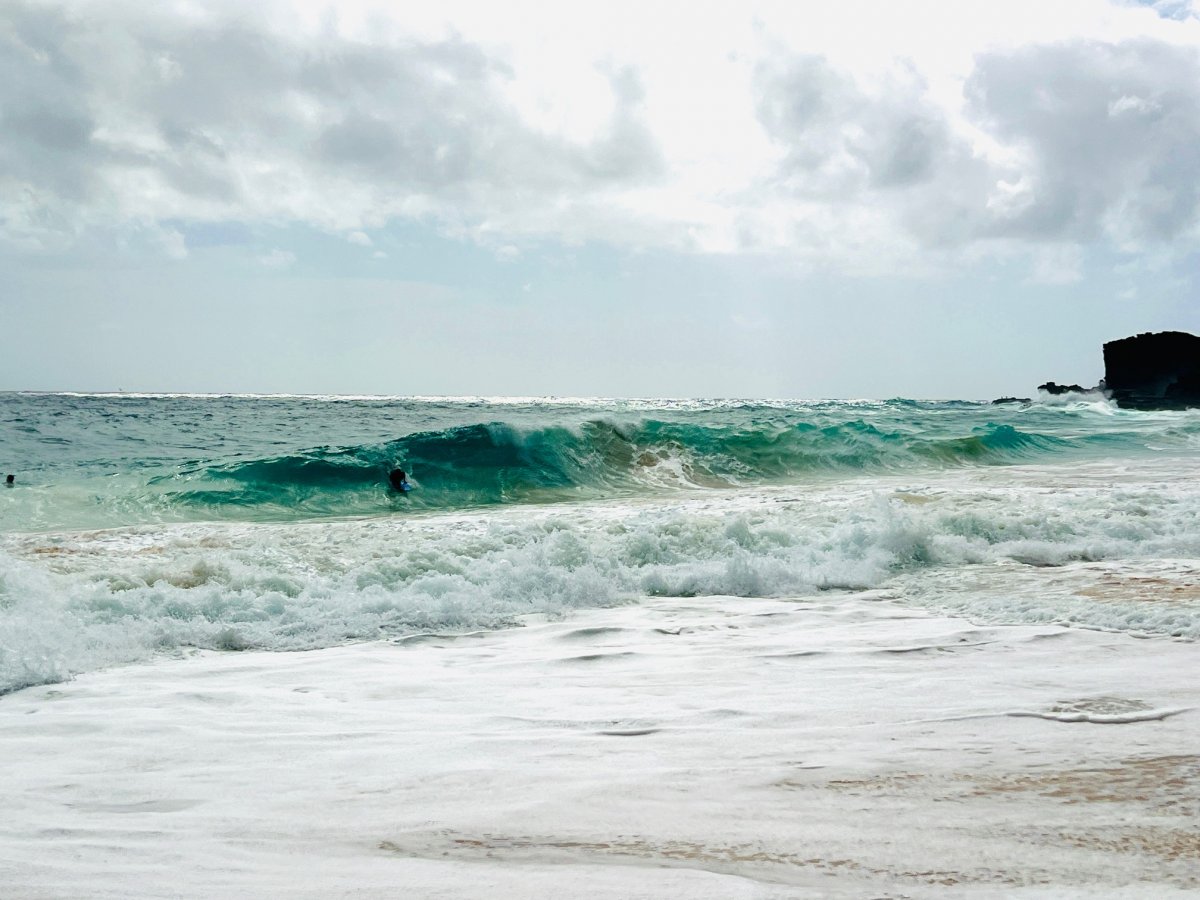 Boogie boarder rides a wave at Sandy Beach on Oahu.