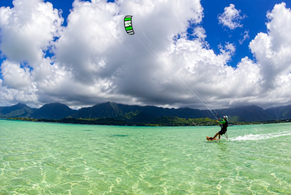 View of kite boarder on Kaneohe Bay with Koolau Mountains in background.