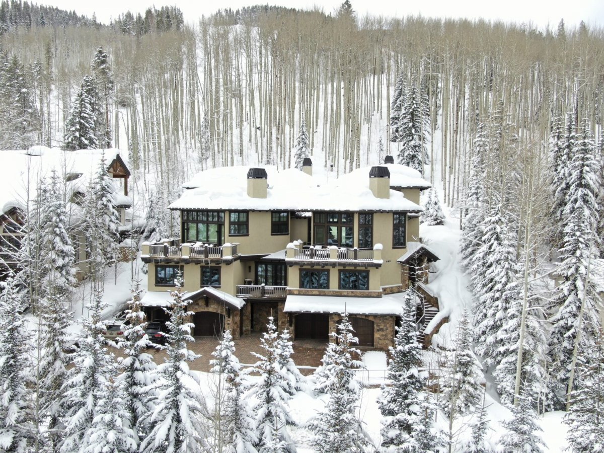 Snowy view of Alpenzauber Lodge in the woods around Vail, Colorado.