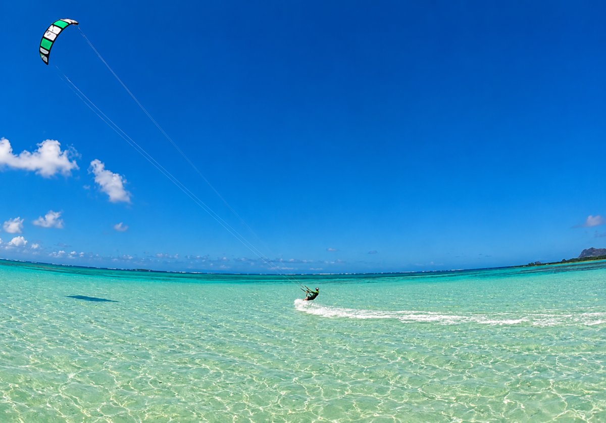 Kaneohe Bay view of kite surfer skimming across blue water