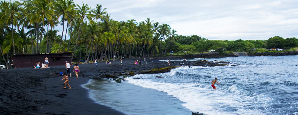 People enjoying Punalu'u Black Sand Beach in the Kau region on the Big Island