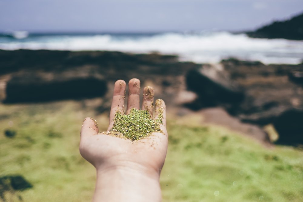 Closeup of green sand at Papakoleaâ beach on the Big Island of Hawaii.