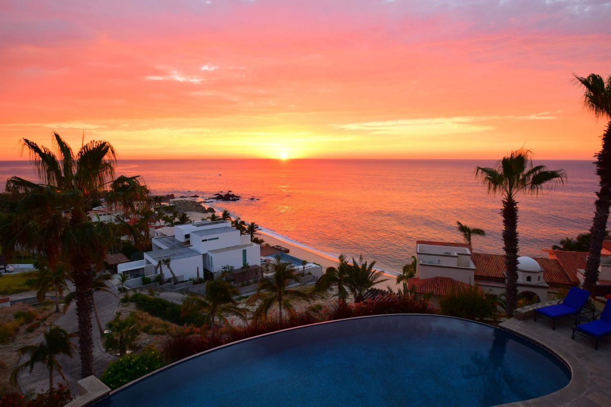 Pink and orange sunrise view from a luxury Cabo villa 