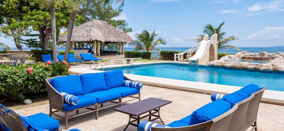 Seven Seas on the Beach pool, slide, and Caribbean view in Ocho Rios, Jamaica.