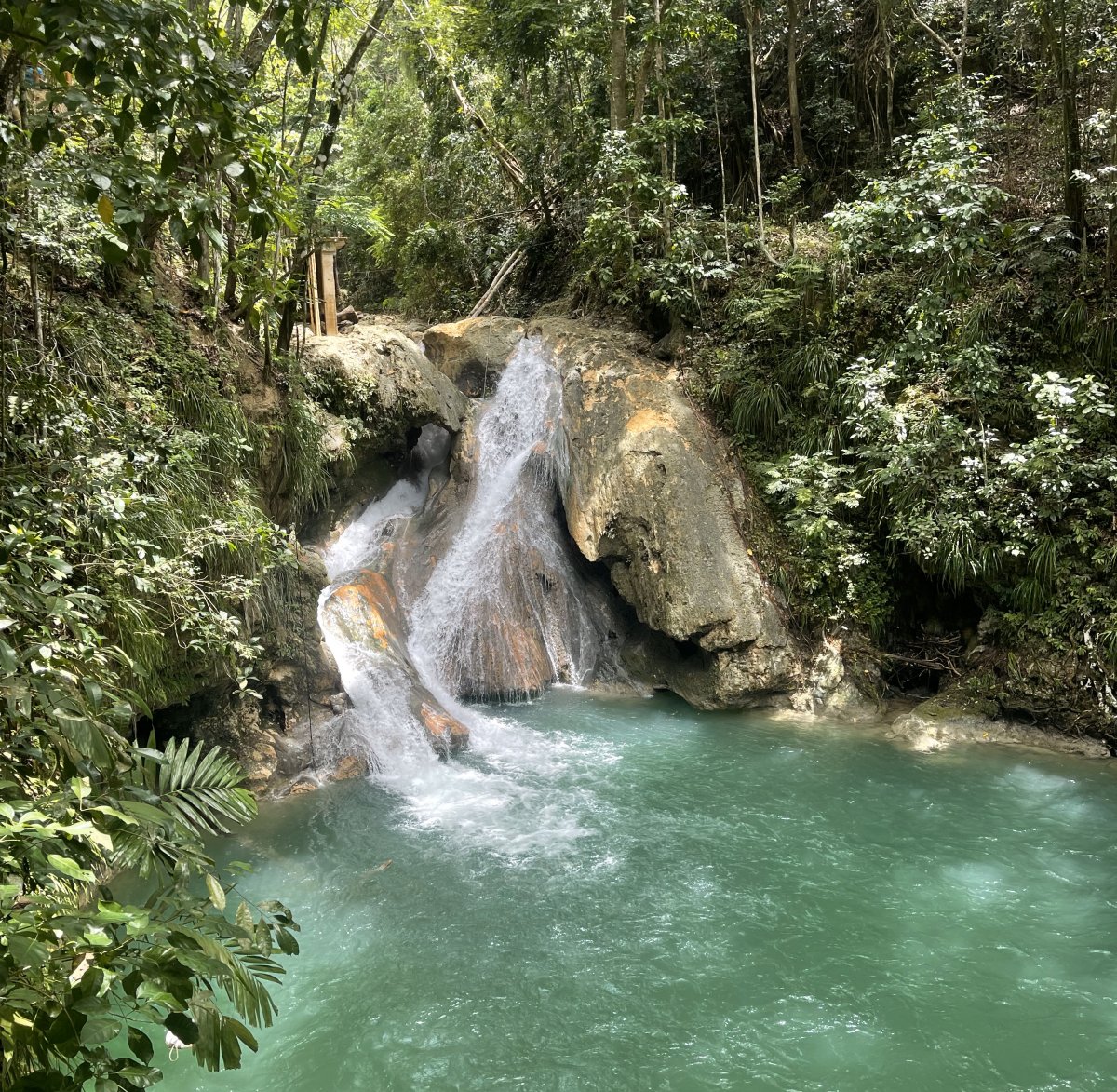 View of the waterfall and blue water at the Blue Hole in Ocho Rios, Jamaica. 