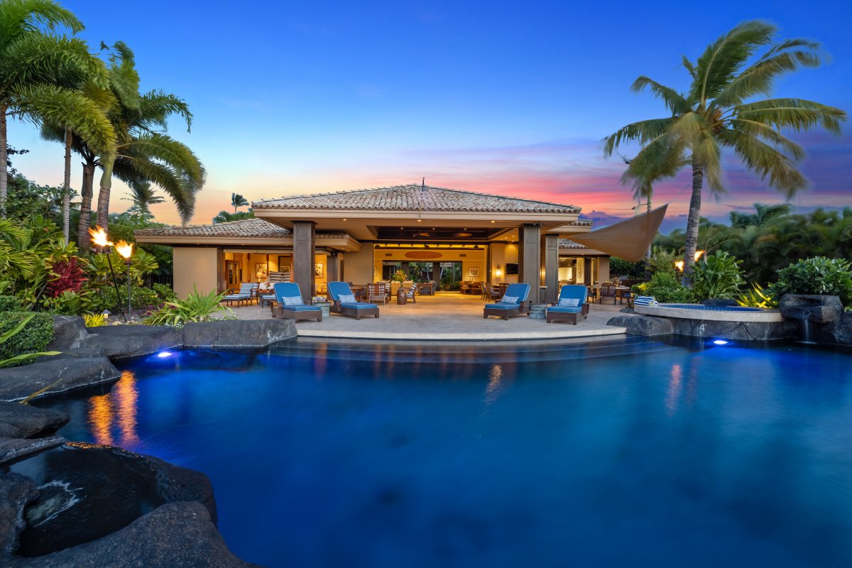 View of Pauoa Beach Oceanfront Villa pool and villa within the gated, luxury enclave of Pauoa Beach, in the Big Islandâs Mauna Lani Resort.