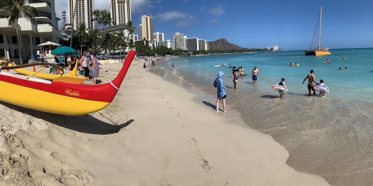View of Waikiki Beach and canoes in Honolulu on the Hawaiian island of Oahu.