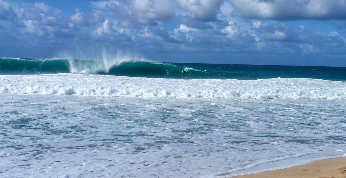 View of Large Banzai Pipeline wave breaking from shore