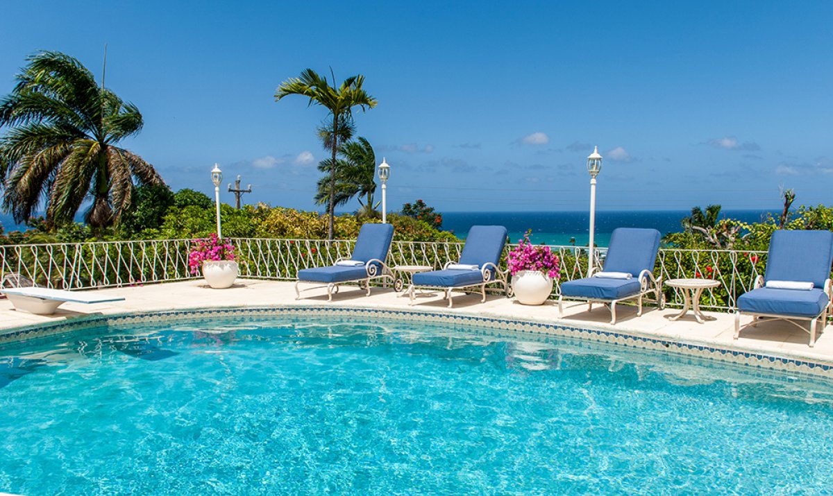 The terrace encircling the heated pool offers guests a stunning blue view over the Caribbean Sea.