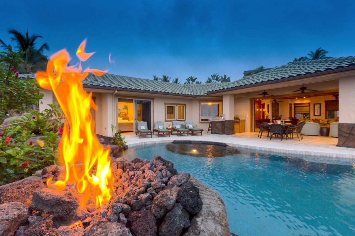 Kona Sunset Villa pool view with built-in volcano-inspired fire pit perfect for evening swimming
