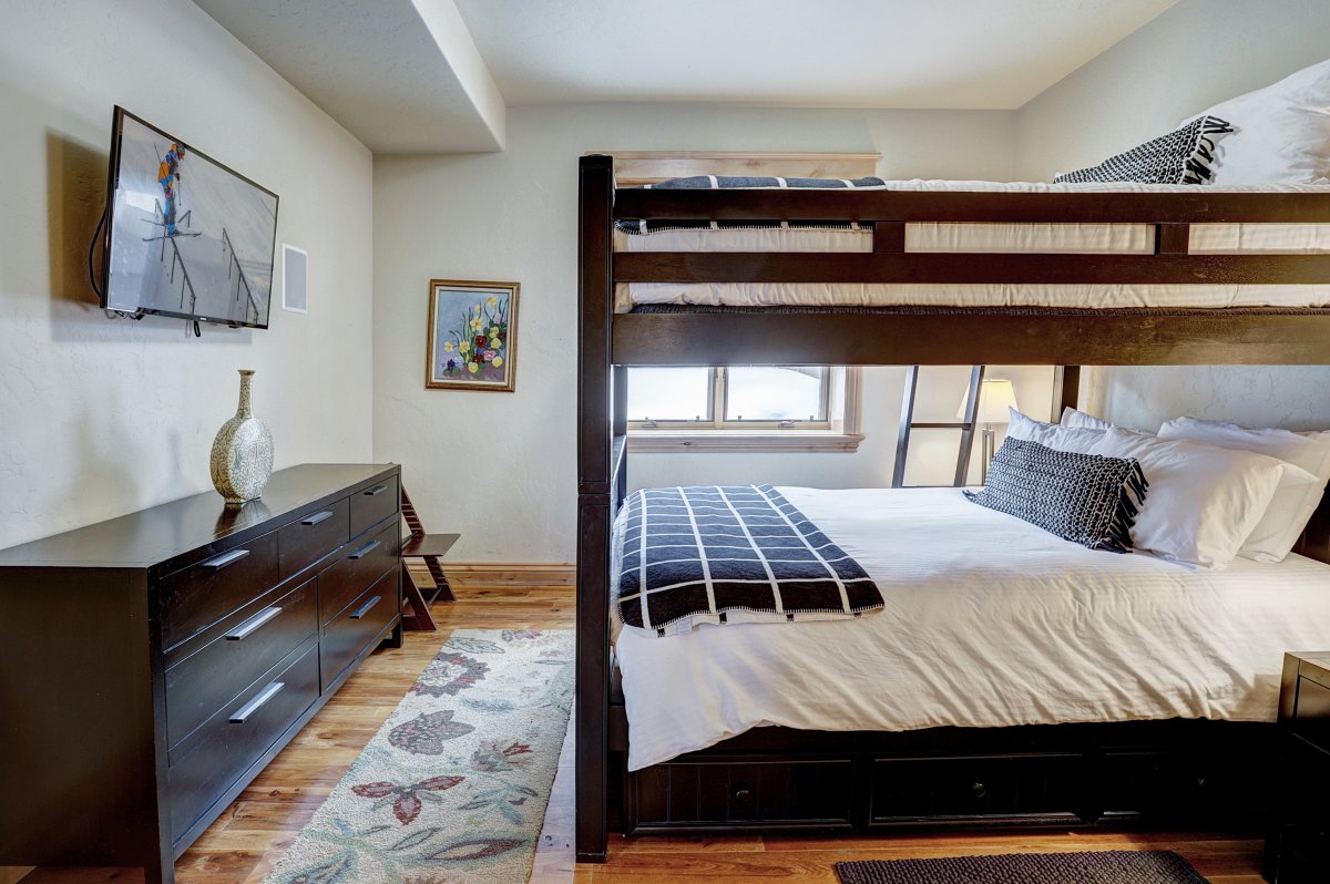 Main level bunk room with flat screen TV and shared bath