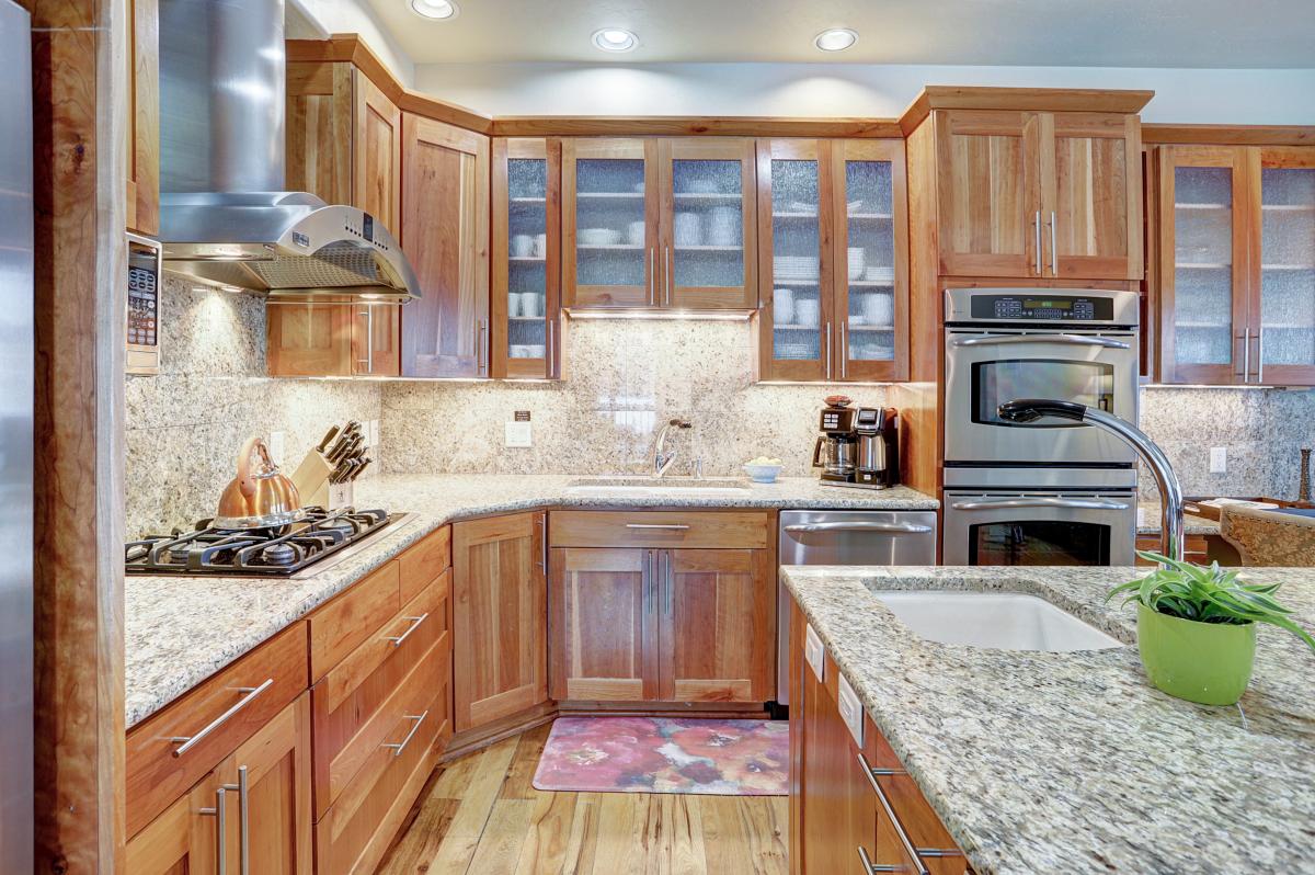 New granite countertops and upgraded cabinetry elevate the kitchen and make it perfect for cooking