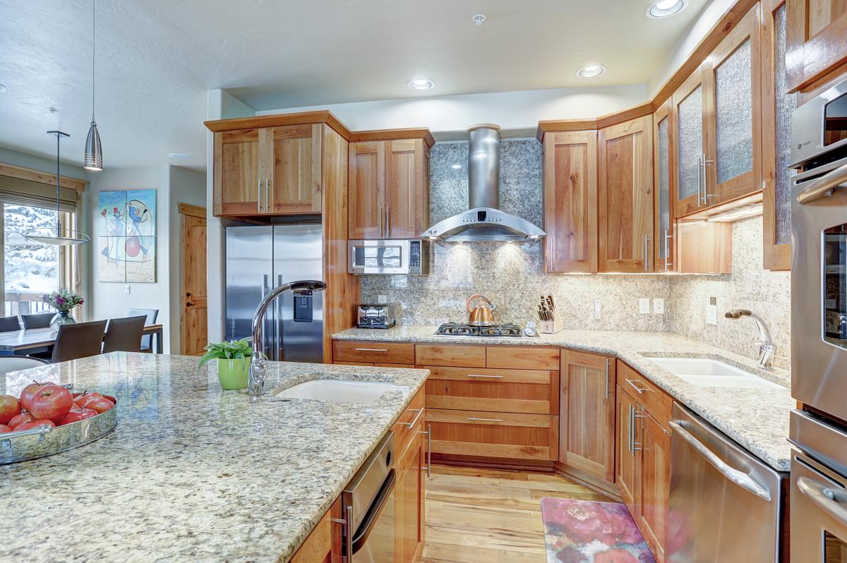 Kitchen is stocked with cookware, bakeware, dishes, glasses, and utensils