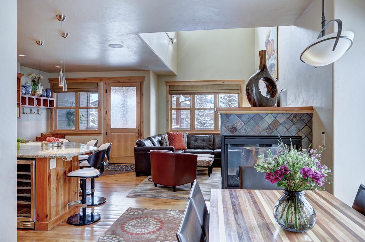 View from dining area of kitchen bar and living room