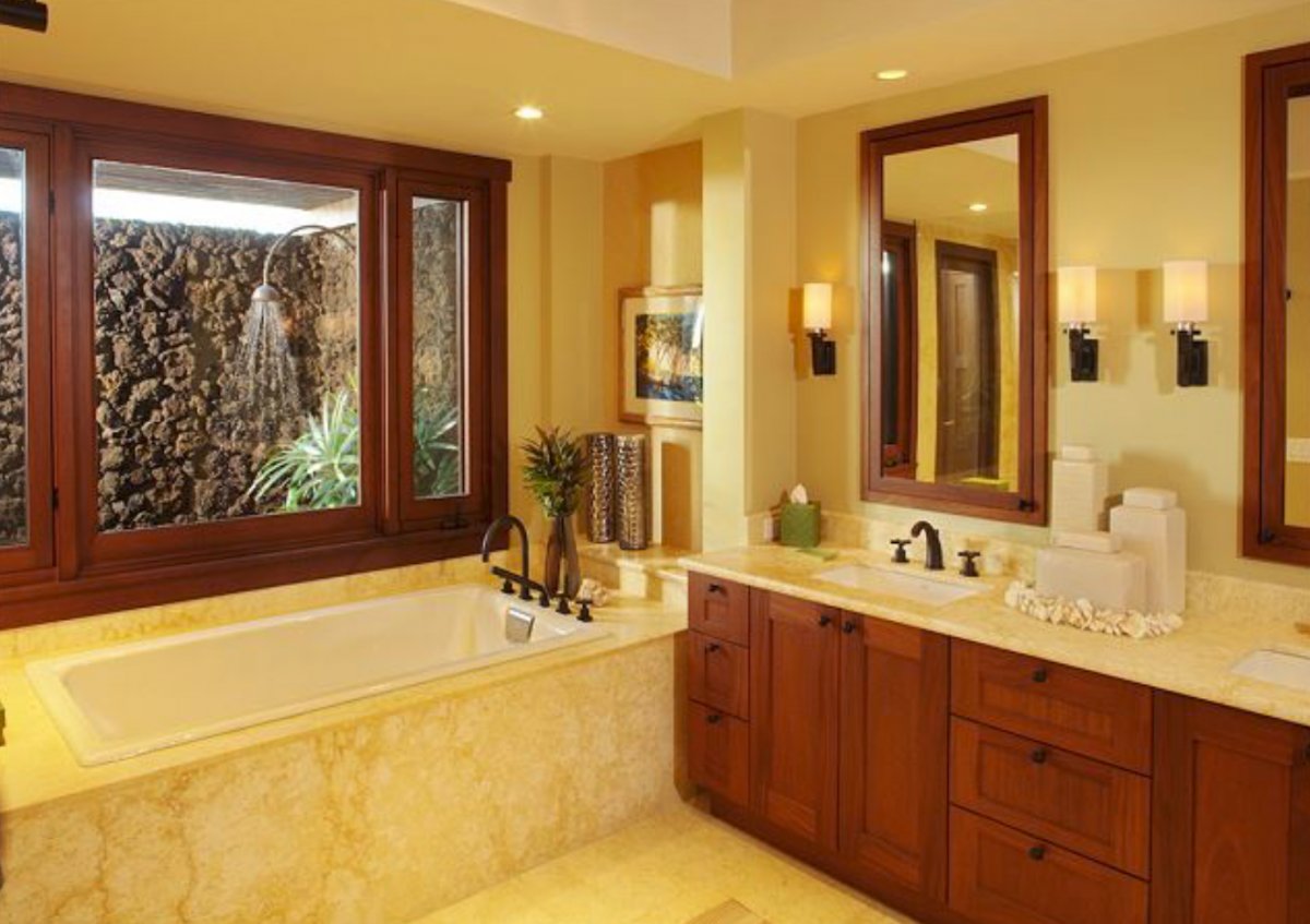 The bathroom's warm tones, combined with the natural light, create a truly spa-like experience