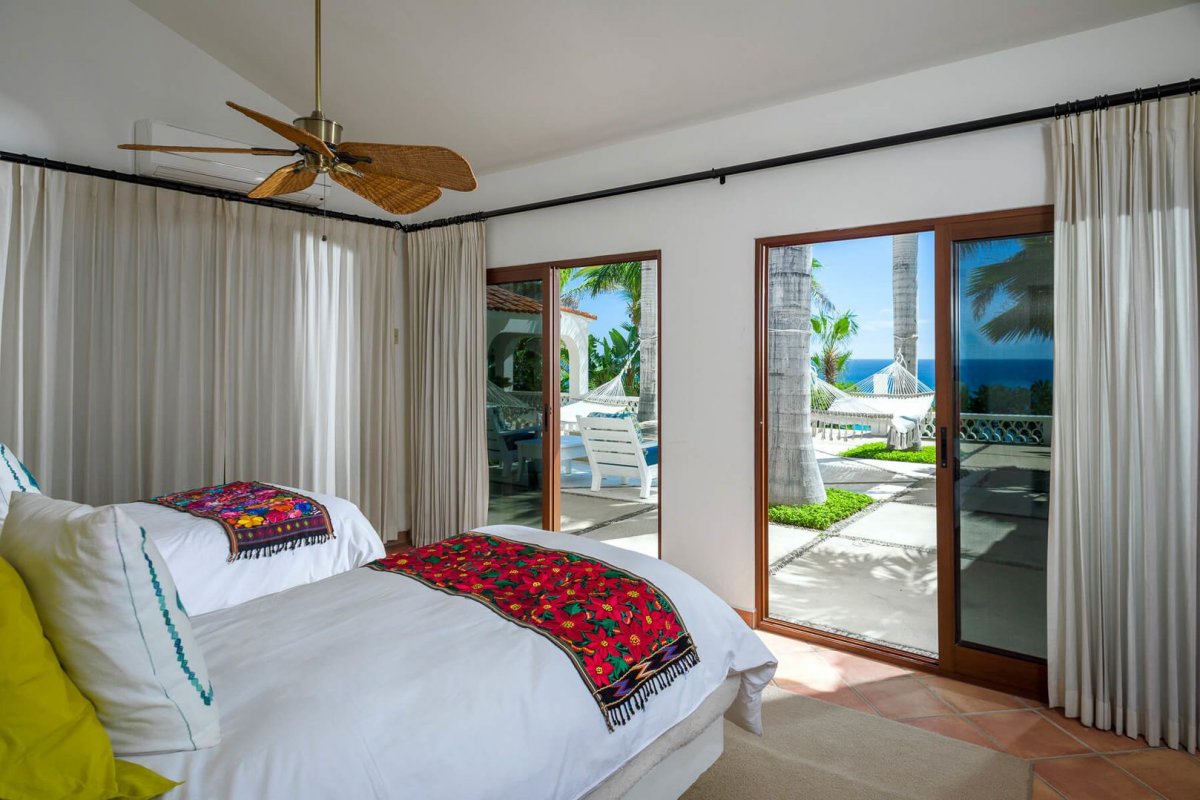 Large, sliding glass doors in place of windows allow the warm Cabo sun to filter into and brighten up the bedrooms!