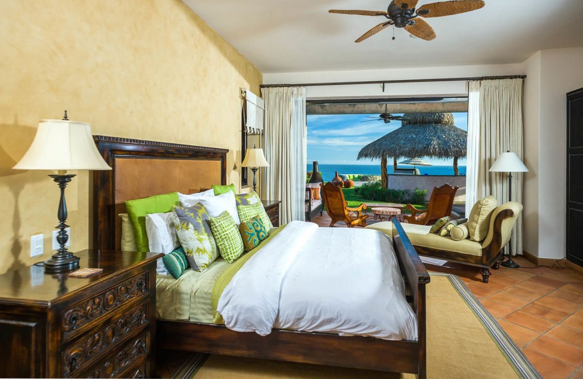 Floor-to-ceiling windows bring in natural lighting that opens up the bedrooms in Villa Estero