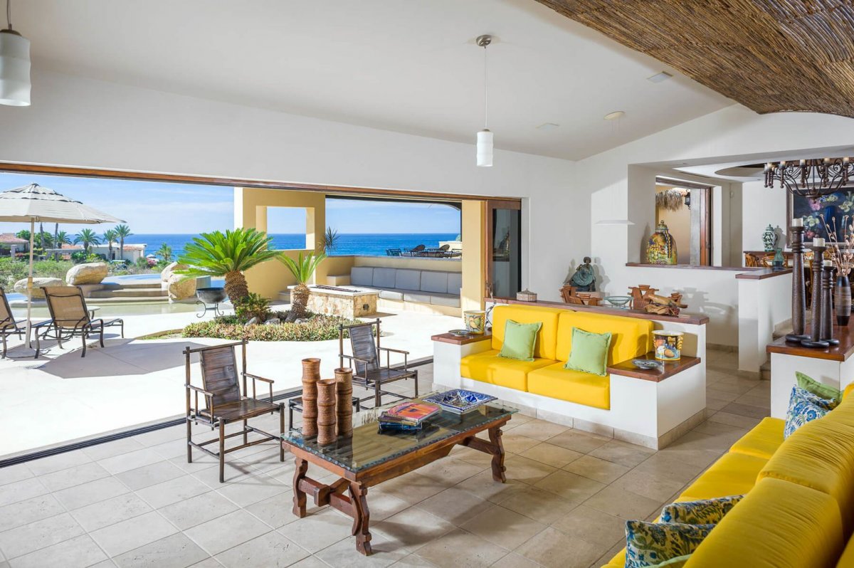 Wide floor-to-ceiling windows allow for a seamless transition from the outdoors to the indoor living area