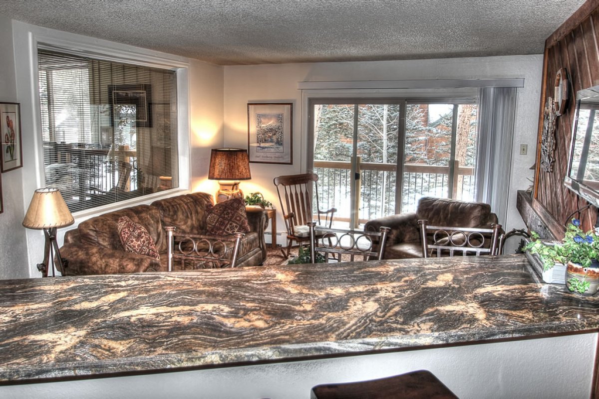 View from kitchen/dining into living room and private balcony