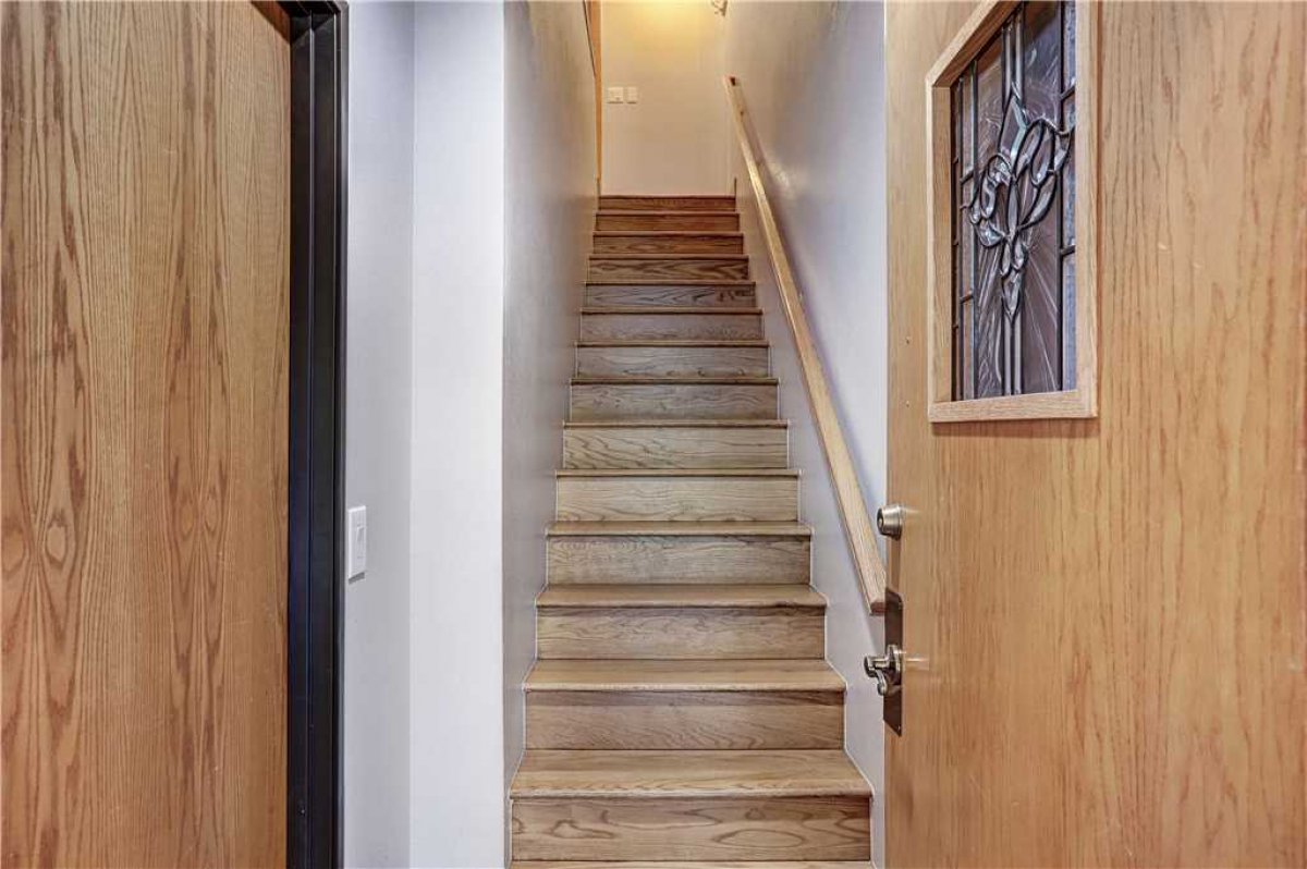 View up the stairs from the front entryway.