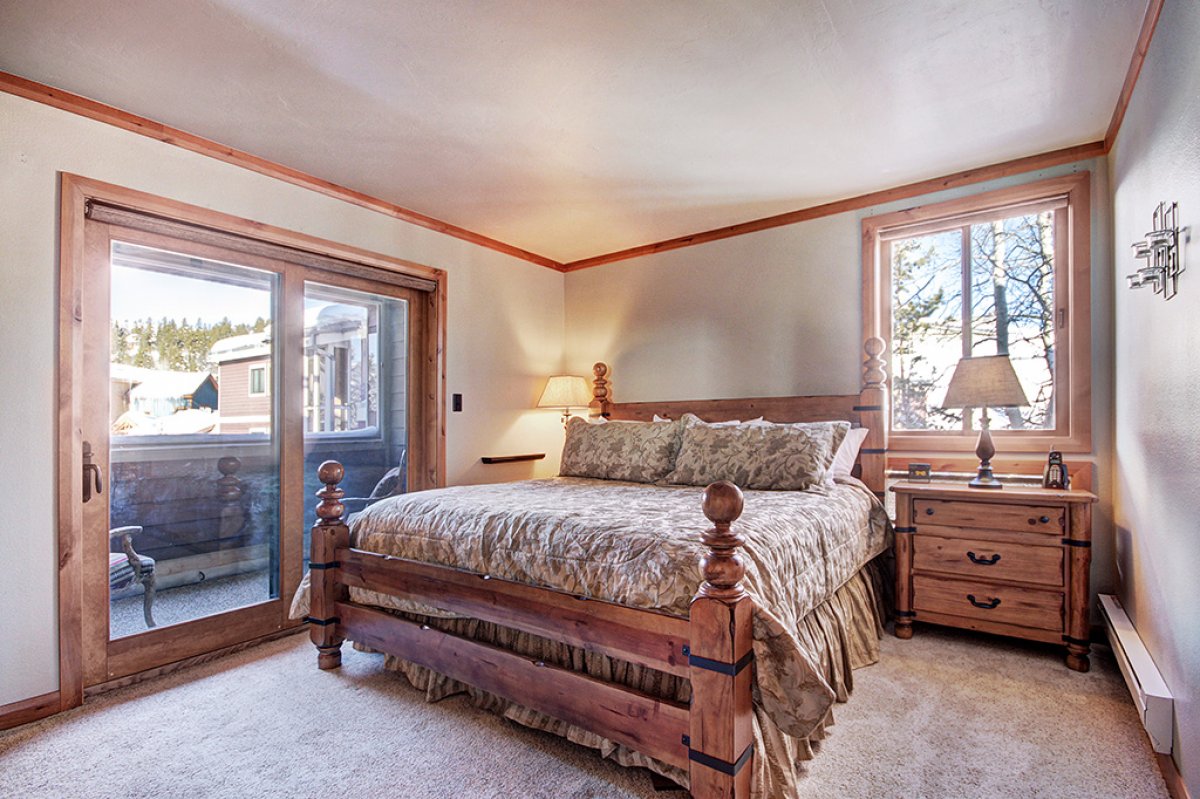 Master bedroom on main level with King-sized bed and private bathroom.