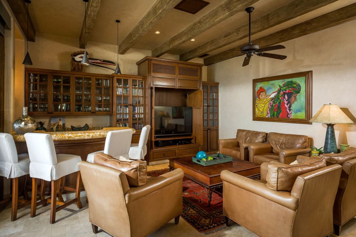 Enjoy a drink at the wet bar while lounging on plush leather chairs