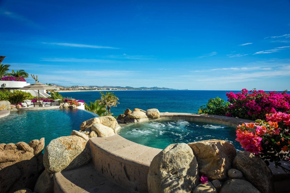 Take a relaxing soak in the Jacuzzi of Villa Gloriosa while being surrounded by lush flowers and a stunning view