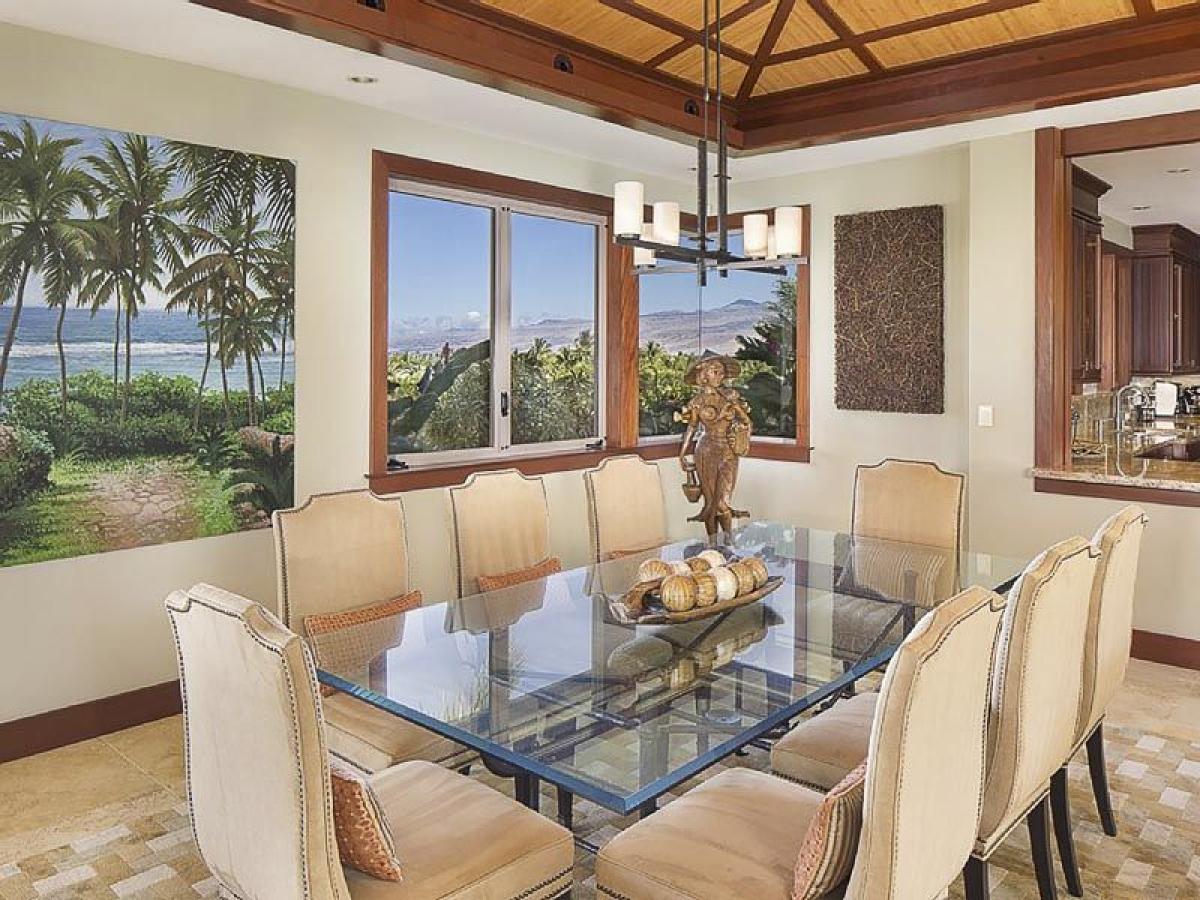 Gather in the bright and airy dining area with table for eight, vaulted ceilings and large glass windows.