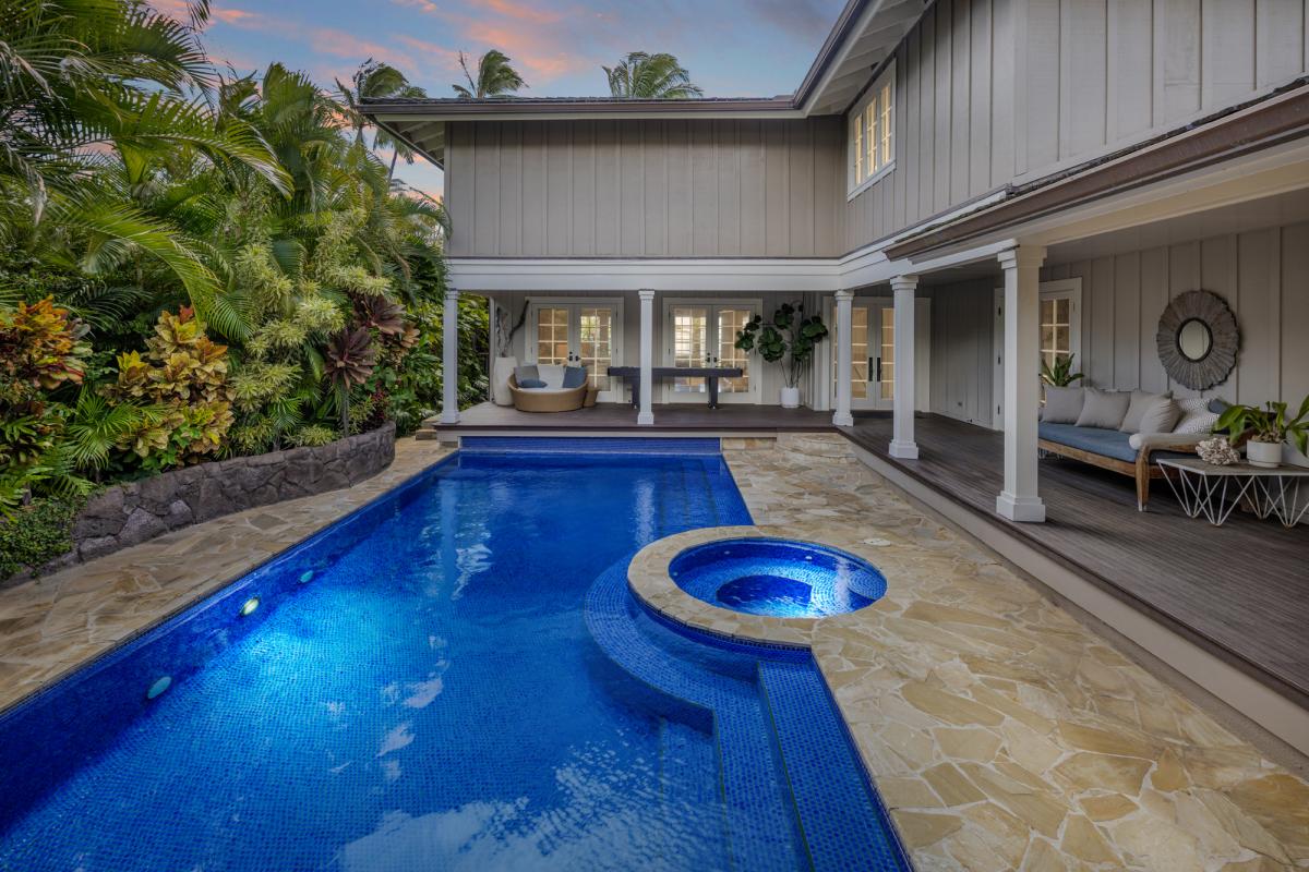 Central pool and hot tub, steps from indoor living.