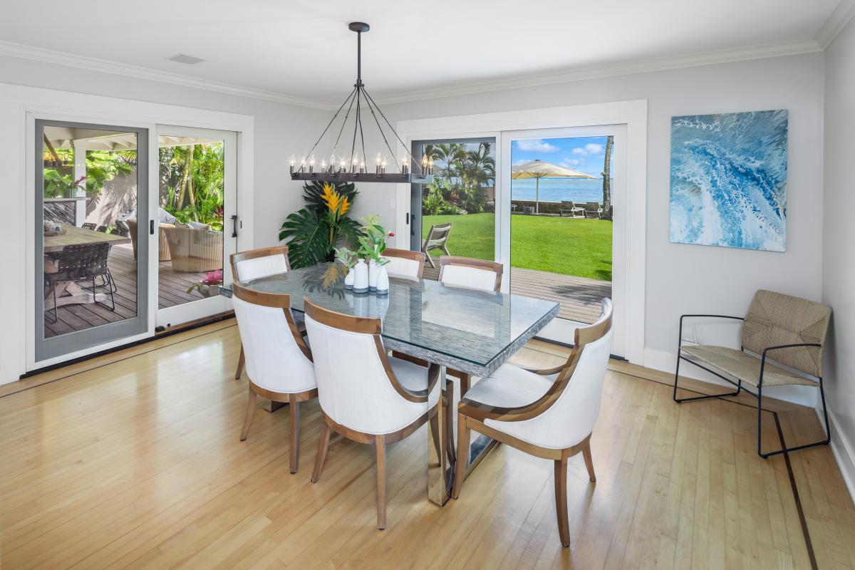 Indoor dining room with seating for six and panoramic ocean views.