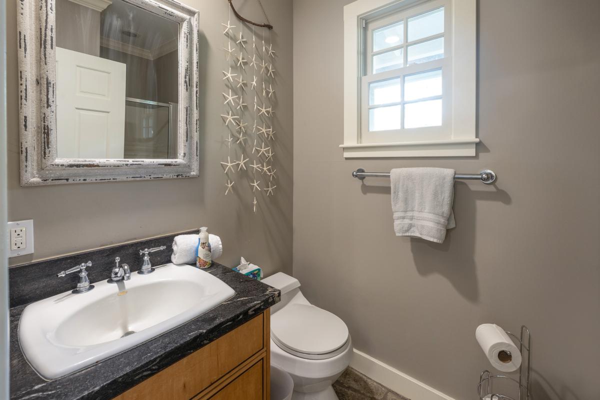 A full bath just off the poolside room keeps mornings and post-beach cleanups easy for additional guests