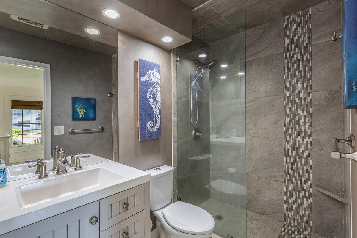 Refresh in the guest ensuite bathroom, complete with a modern vanity and a spacious walk-in shower designed for everyday comfort.