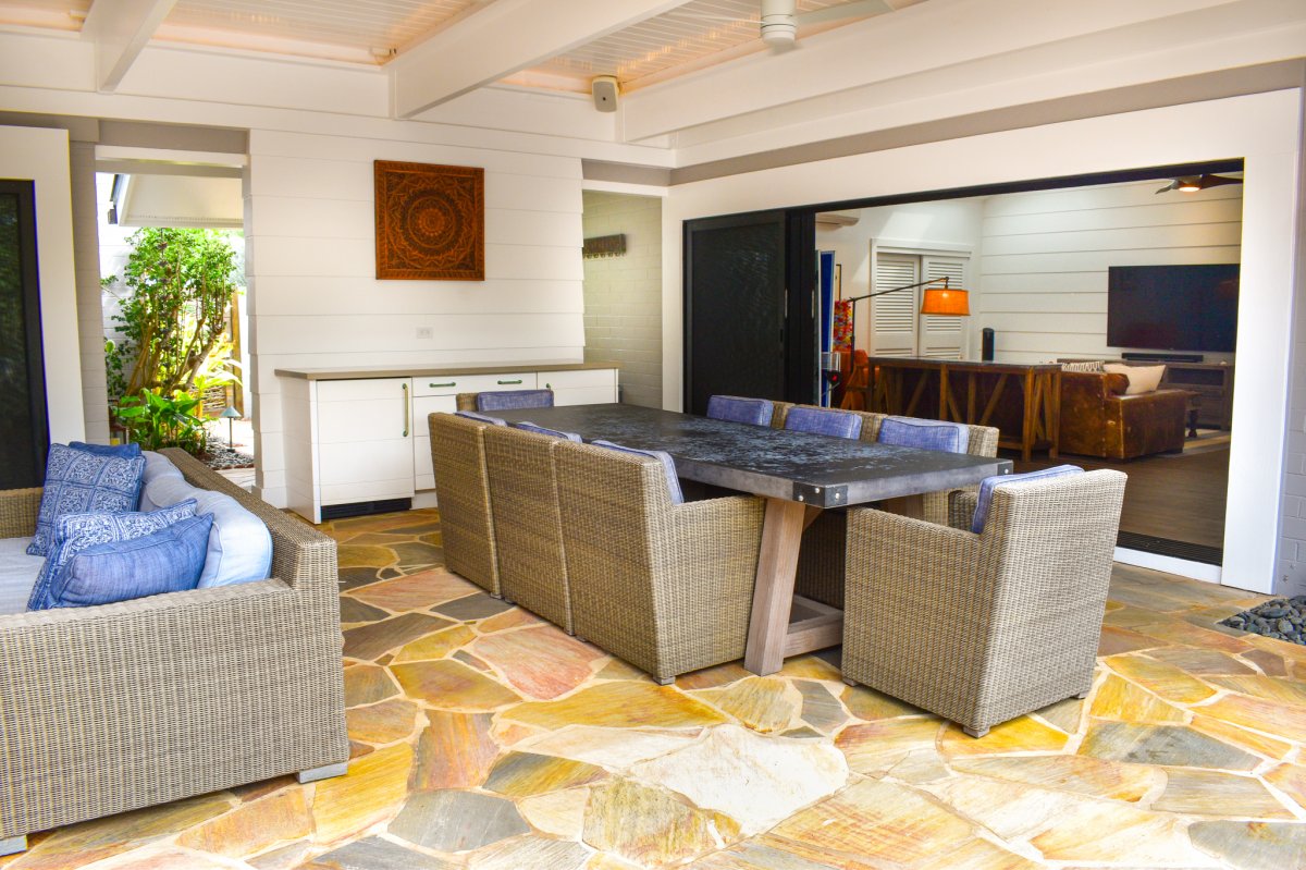 Hale Ohana's open-design outdoor sitting and dining area connected to the indoor living room