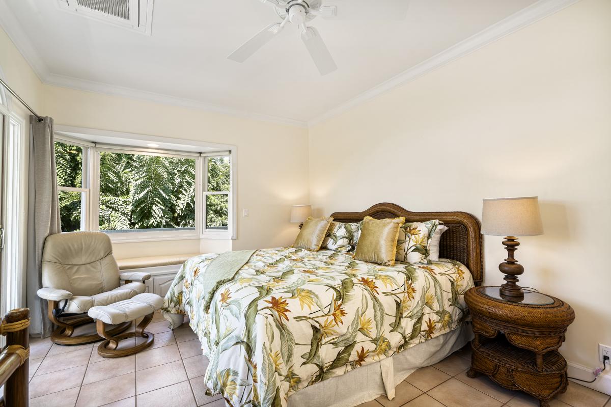 Spacious 316 sq ft. upstairs guest bedroom with garden views and natural light.