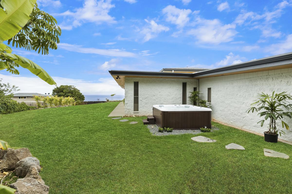 Soak in the private jacuzzi set on a peaceful lawn with open sky and sunset potential.