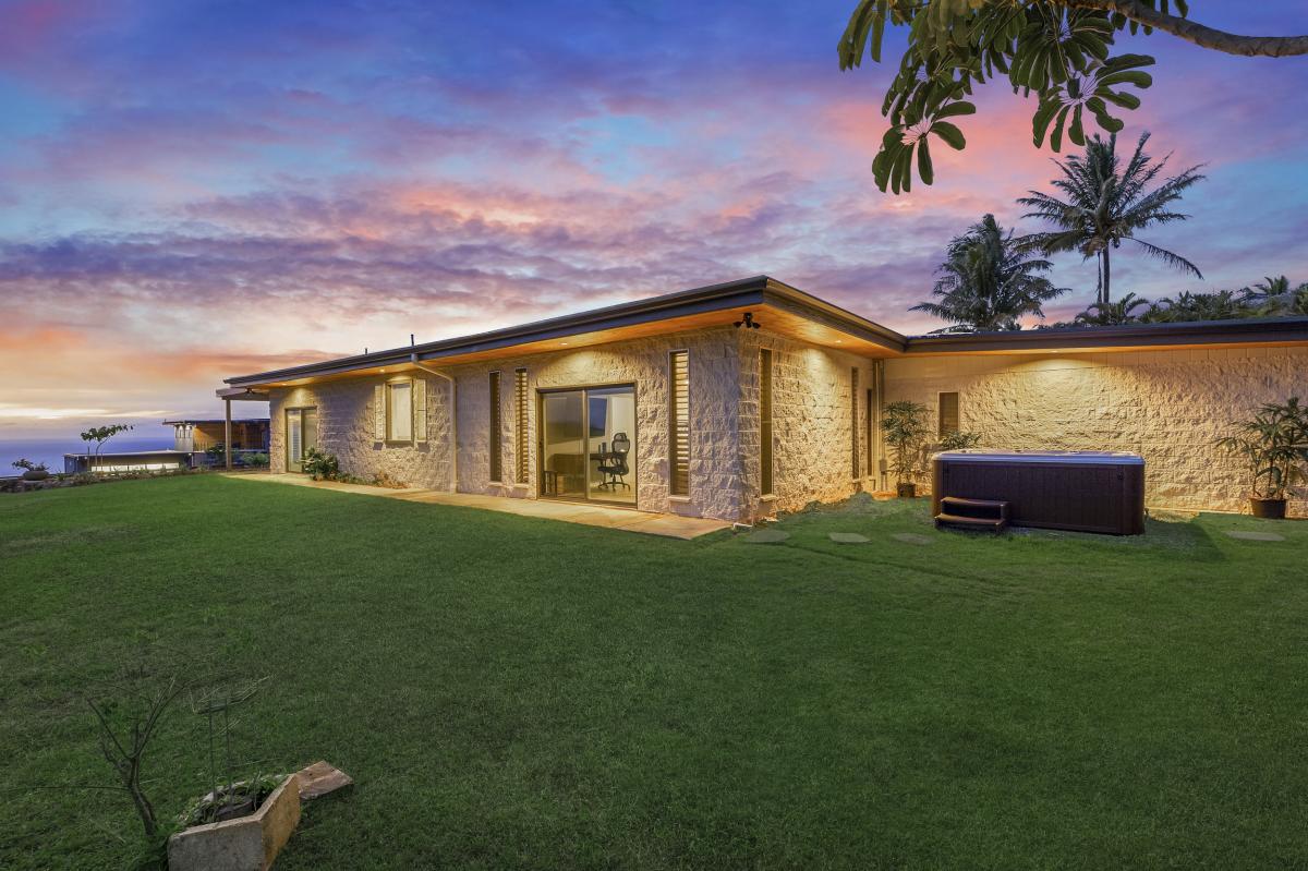 Twilight hues settle over the gated, half-acre hillside estate.