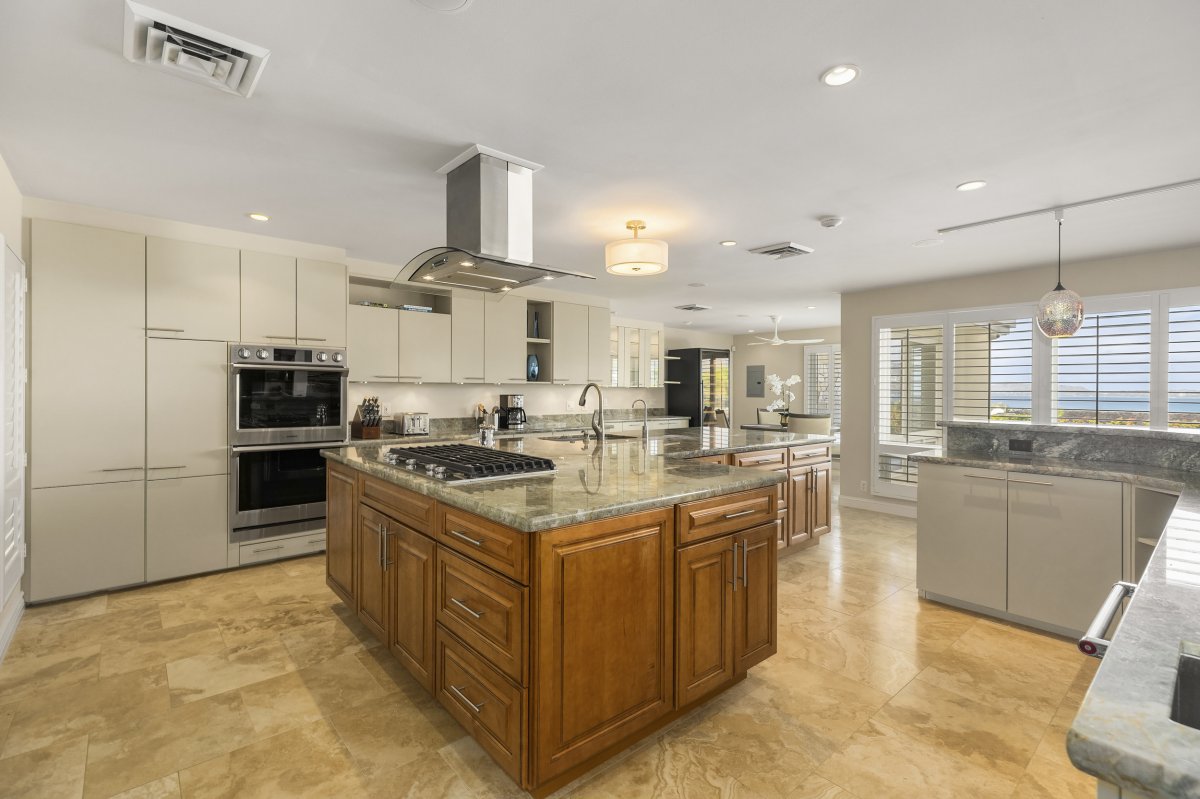 Hale Makana's beautiful and functional kitchen area with a large island in the center of the kitchen and equipped with stainless steel appliances