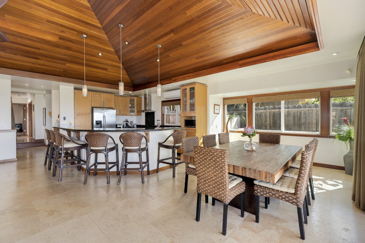 Hale Makai boasts a spacious kitchen, ideal for meal preparation, along with a dining area featuring a table that comfortably seats 8 people