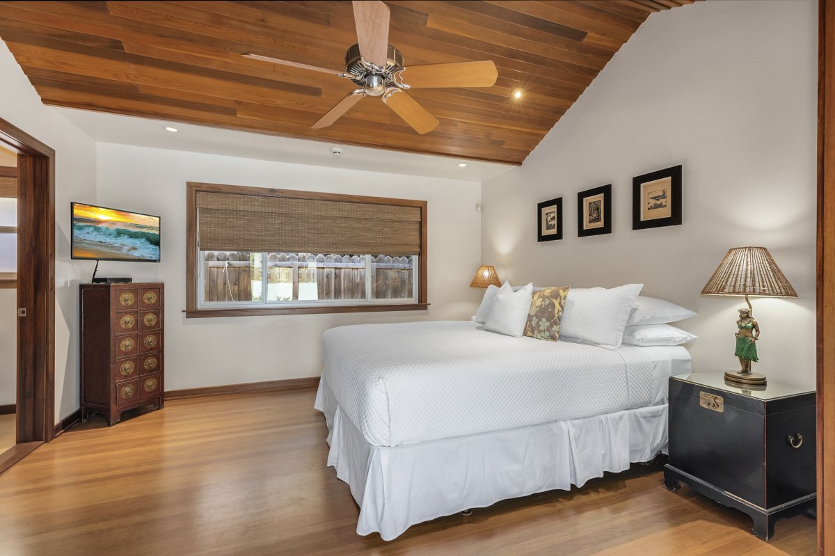 Hale Makai's Second Bedroom furnished with King size bed, ceiling fan and flat-screen TV