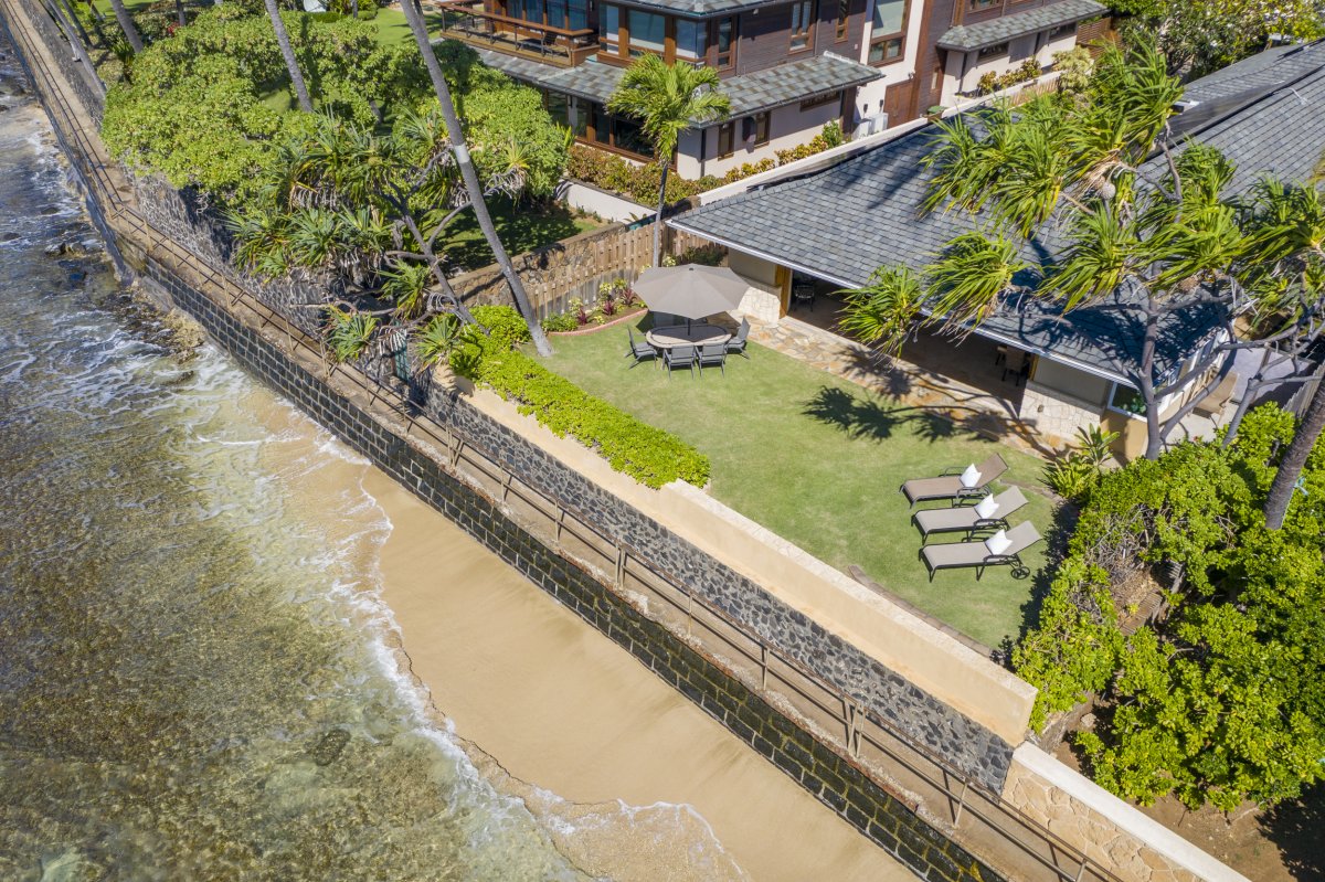 Breathtaking aerial view of Hale Makai at Diamond Head, a luxurious oceanfront vacation rental home nestled along the pristine Gold Coast of Oahu