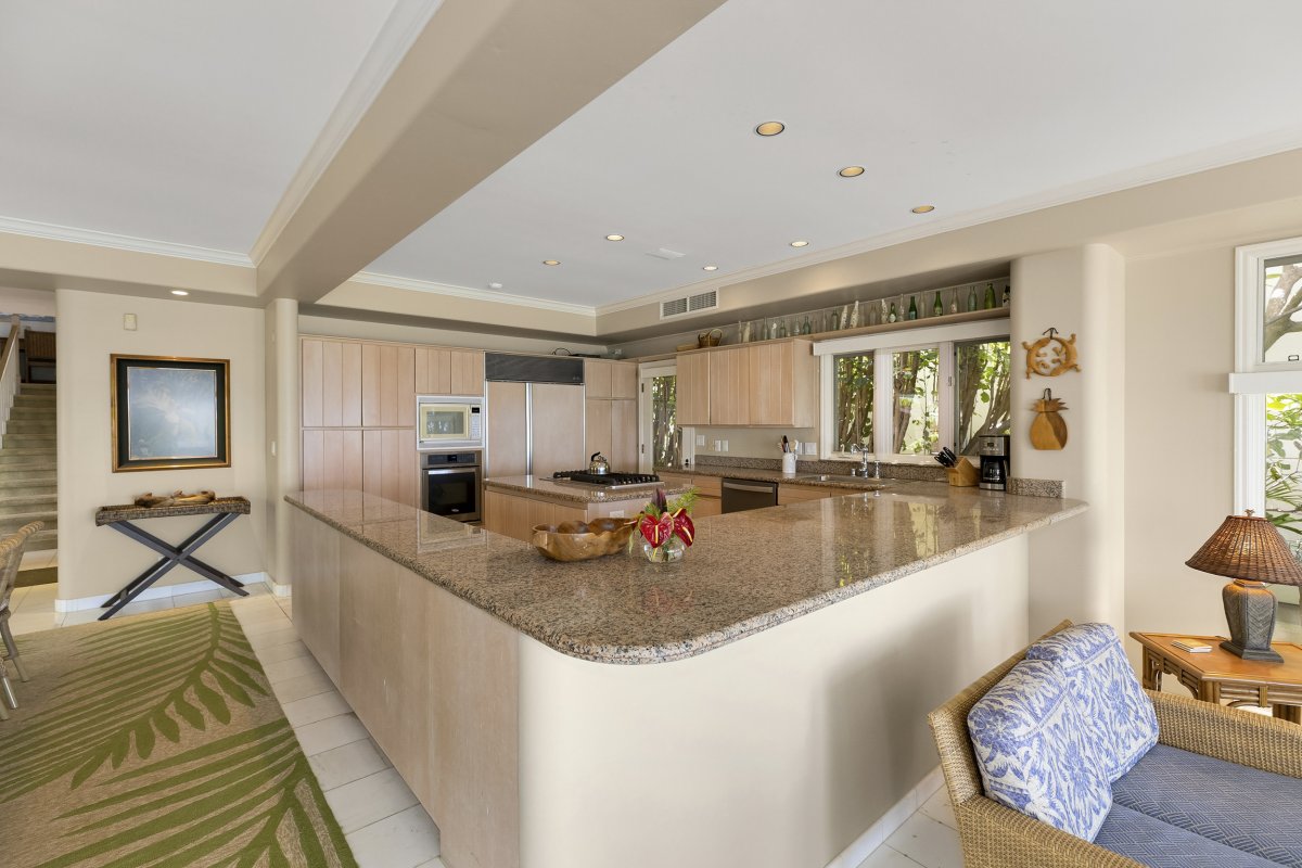 Spacious kitchen with fully equipped appliances and counter space at Diamond Head Surf House on Oahu