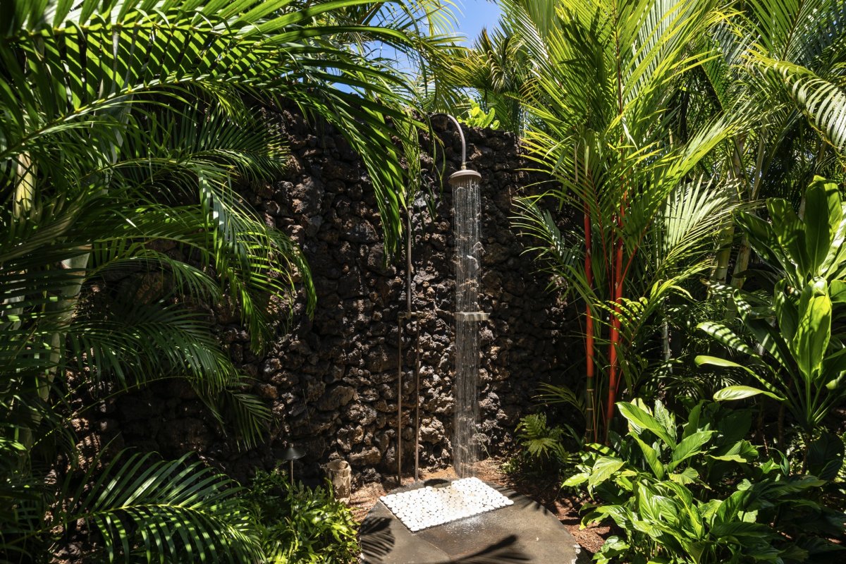 The private outdoor shower garden offers a serene, tropical escape.