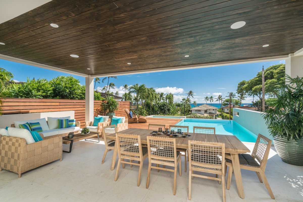 Pool with an attached jacuzzi spa and ocean views from the covered private lanai at Diamond Head Grandeur Villa on Oahu