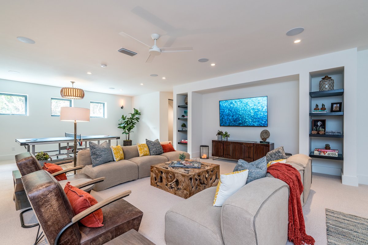 Diamond Head Grandeur Villa entertainment room with sectional couch, flat screen TV, and table tennis table next to it