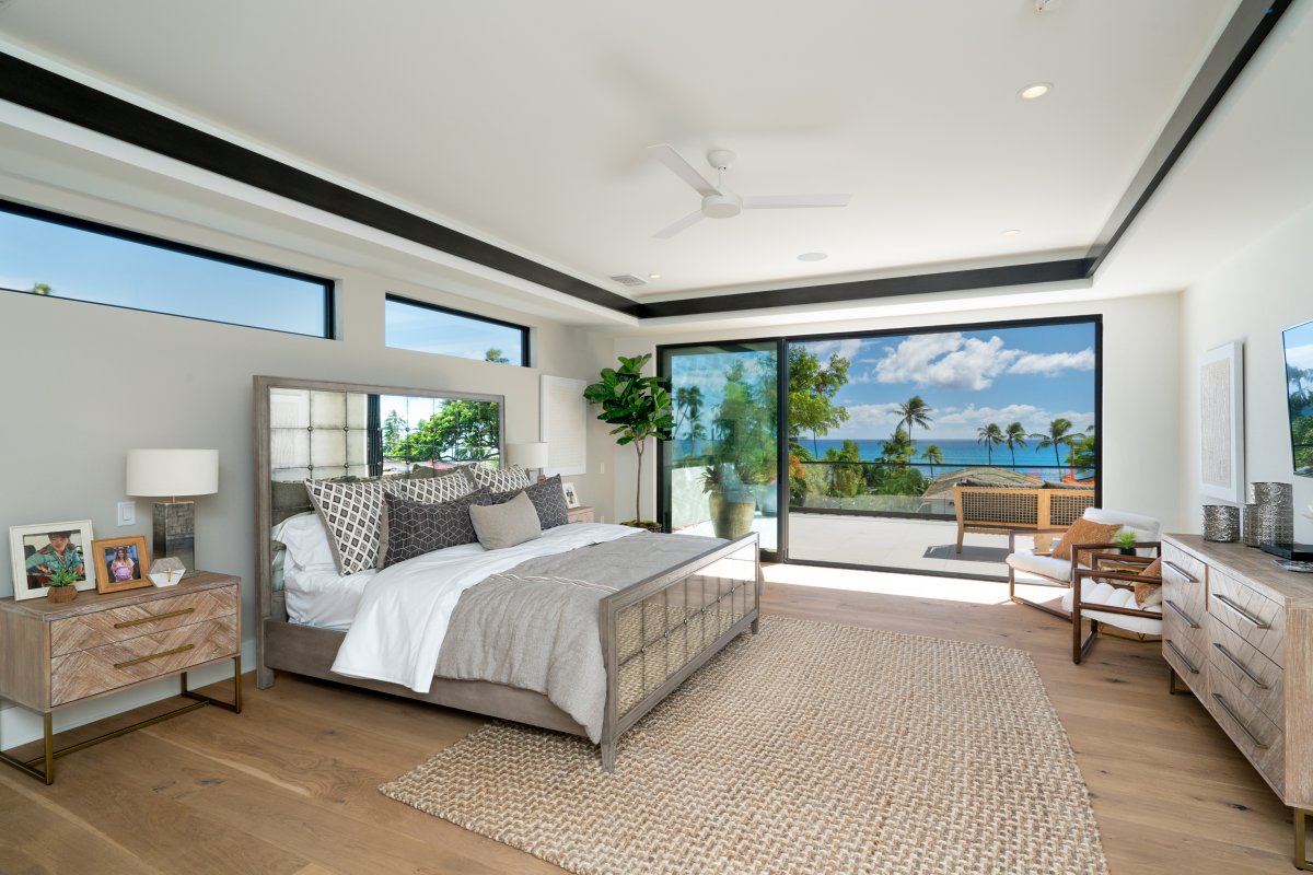 Primary bedroom of Diamond Head Grandeur Villa on Oahu with a king bed, terrace, and stunning ocean views