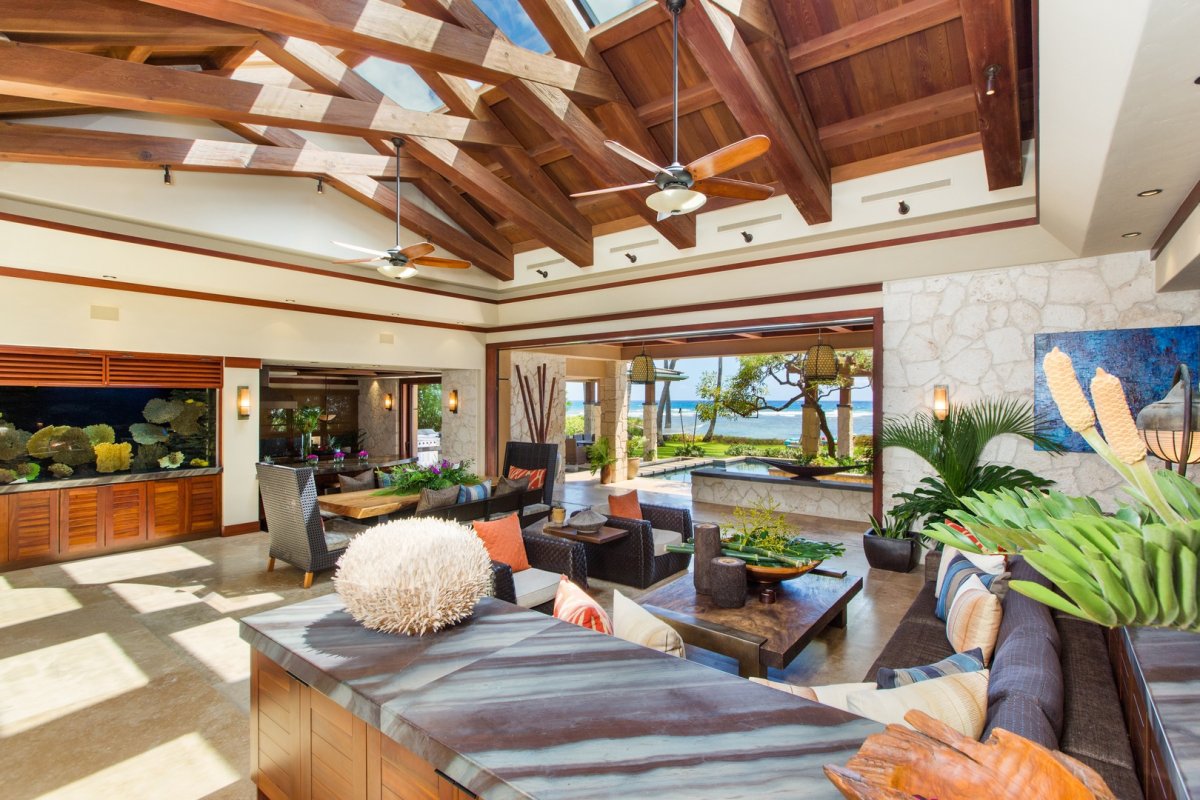 Living roomn with a counter, sofas, and lanai garden view