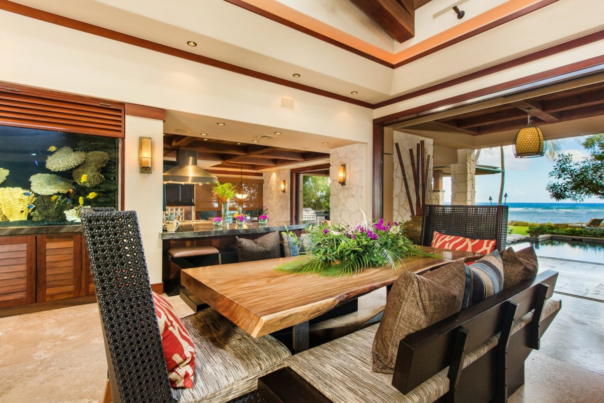 Dining area with an aquarium, lanai, and ocean view