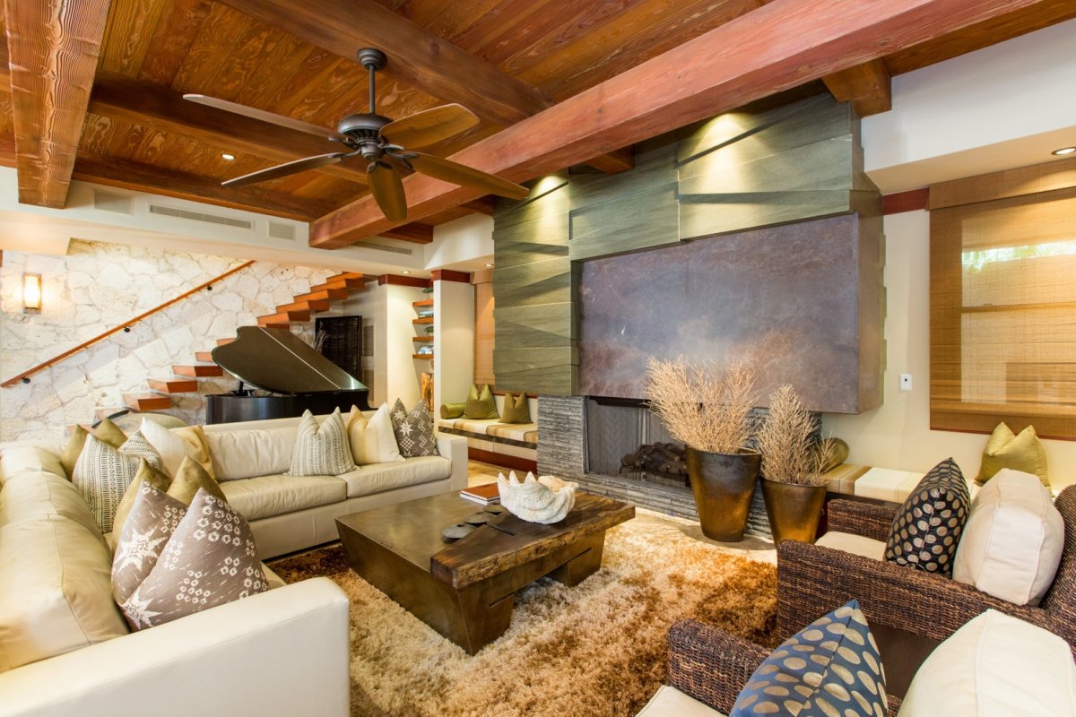 Living room view with grand piano, fireplace, and a stairway leading to the second floor