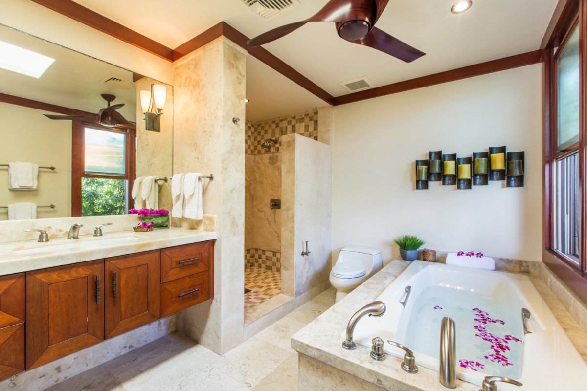 En-suite bathroom with ceiling fan, toilet, shower, bathtub and vanity area