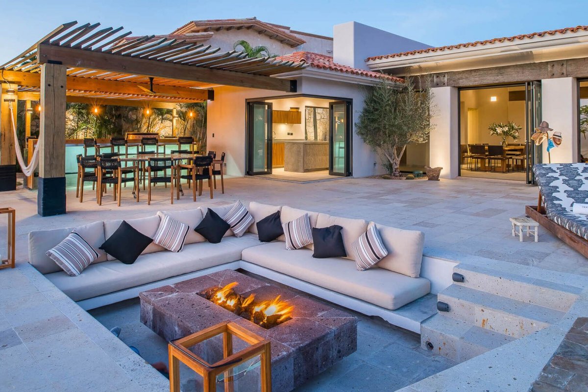 Gather around the fire pit in the evenings on the plush cushions of the outdoor sofa!